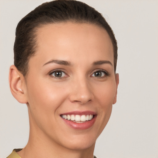 Joyful white young-adult female with short  brown hair and brown eyes