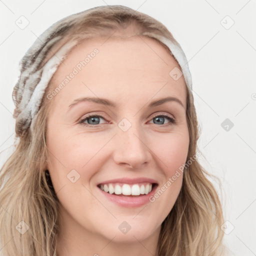 Joyful white young-adult female with long  brown hair and blue eyes