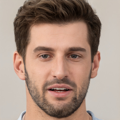 Joyful white young-adult male with short  brown hair and brown eyes