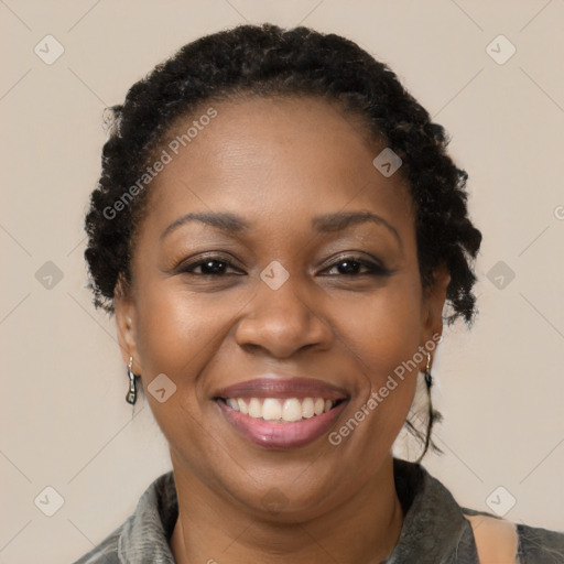 Joyful black adult female with short  brown hair and brown eyes