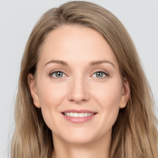 Joyful white young-adult female with long  brown hair and grey eyes