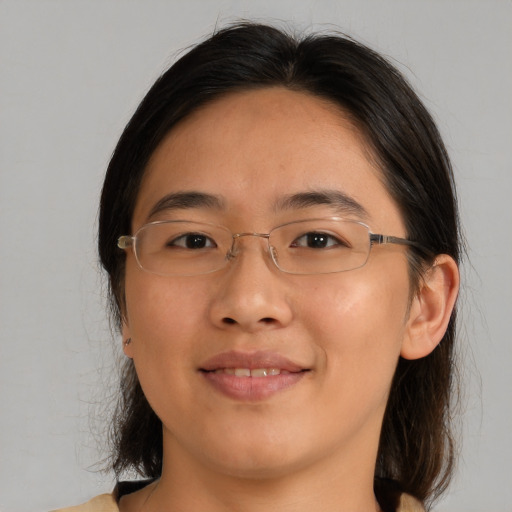 Joyful asian young-adult female with medium  brown hair and brown eyes