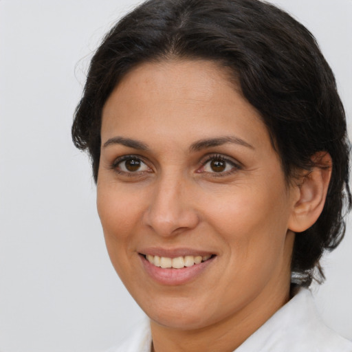 Joyful white adult female with medium  brown hair and brown eyes