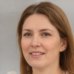 Joyful white adult female with long  brown hair and brown eyes