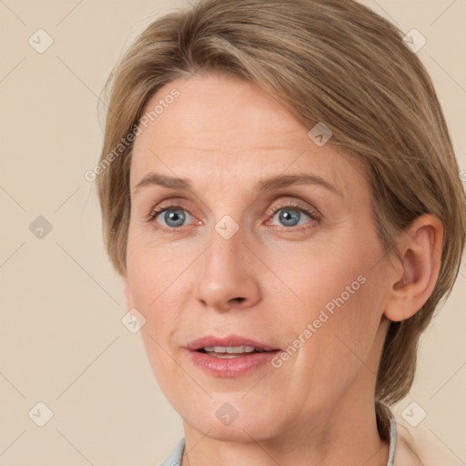 Joyful white adult female with medium  brown hair and blue eyes