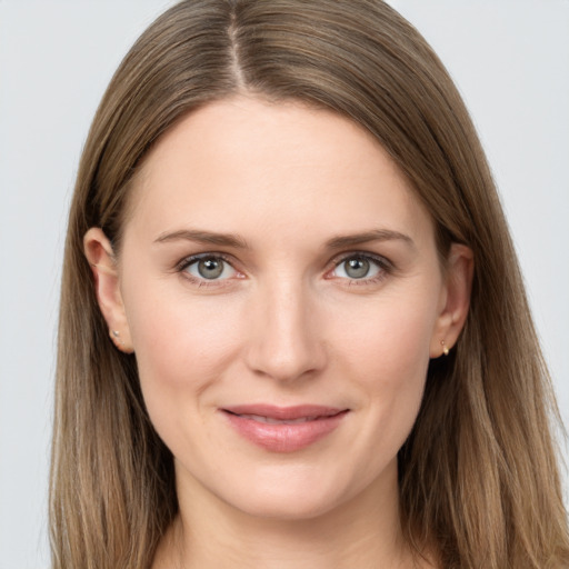 Joyful white young-adult female with long  brown hair and grey eyes