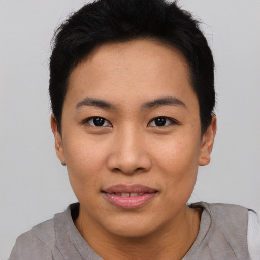 Joyful asian young-adult female with short  black hair and brown eyes