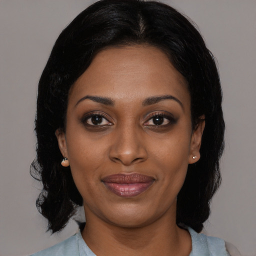 Joyful black young-adult female with medium  black hair and brown eyes
