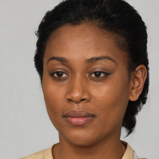 Joyful black young-adult female with short  brown hair and brown eyes
