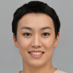 Joyful asian young-adult female with short  black hair and brown eyes