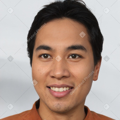 Joyful asian young-adult male with short  black hair and brown eyes