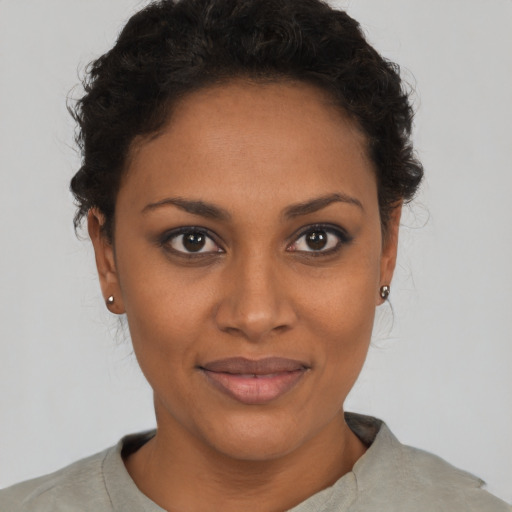 Joyful black young-adult female with short  brown hair and brown eyes