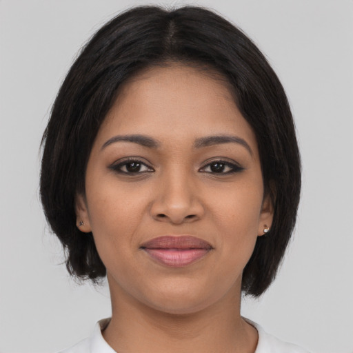 Joyful latino young-adult female with medium  black hair and brown eyes