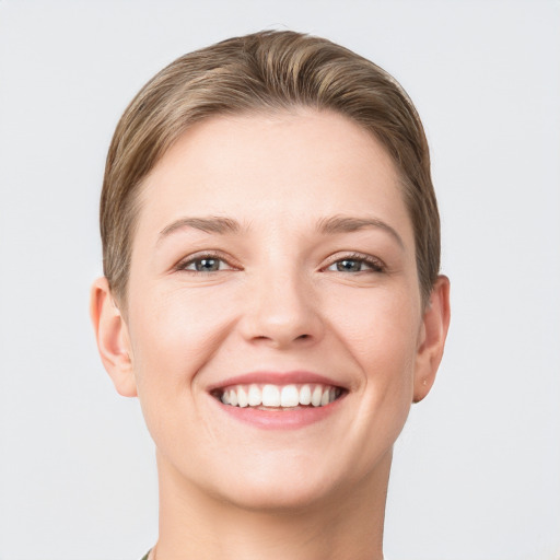 Joyful white young-adult female with short  brown hair and grey eyes