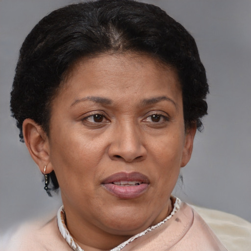 Joyful latino adult female with short  brown hair and brown eyes