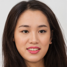 Joyful asian young-adult female with long  brown hair and brown eyes