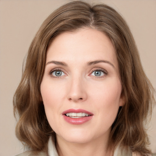 Joyful white young-adult female with medium  brown hair and green eyes