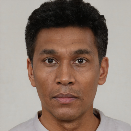 Neutral latino adult male with short  black hair and brown eyes