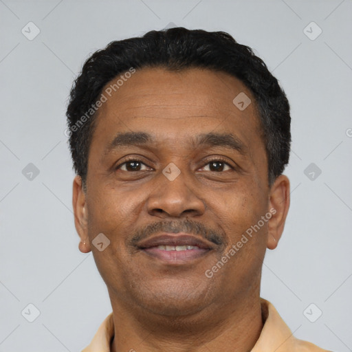 Joyful black adult male with short  black hair and brown eyes