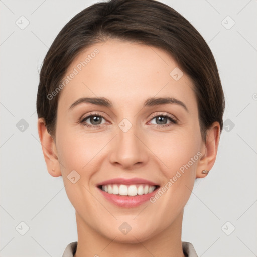 Joyful white young-adult female with short  brown hair and brown eyes