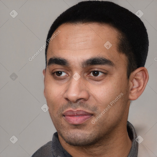 Joyful white young-adult male with short  black hair and brown eyes