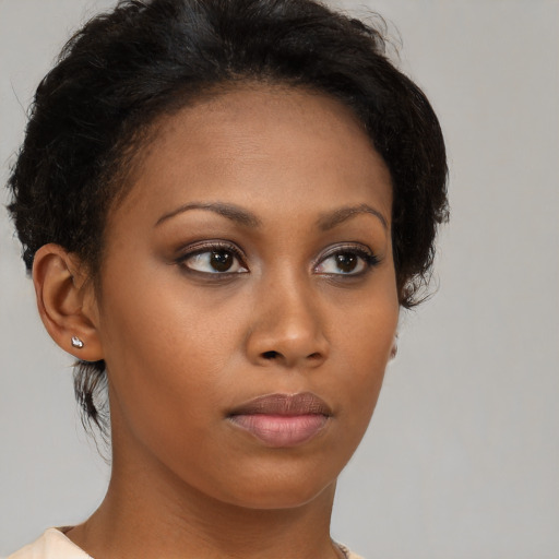 Neutral black young-adult female with medium  brown hair and brown eyes