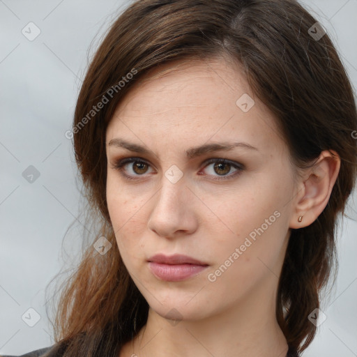 Neutral white young-adult female with long  brown hair and brown eyes