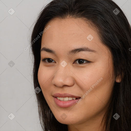 Joyful asian young-adult female with long  brown hair and brown eyes