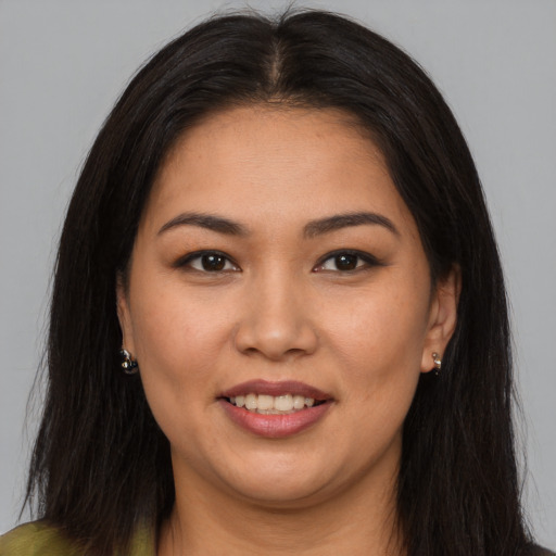 Joyful latino young-adult female with long  brown hair and brown eyes