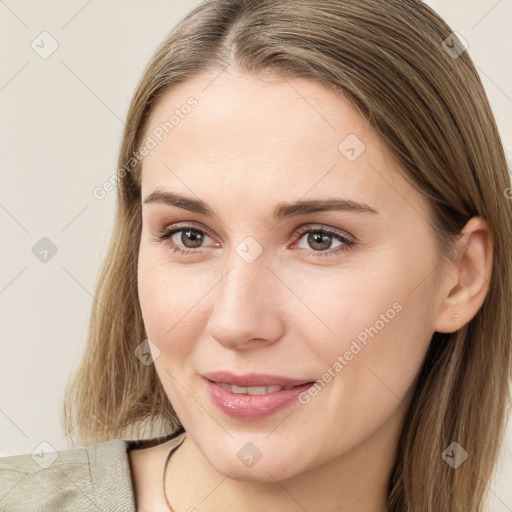 Joyful white young-adult female with long  brown hair and brown eyes