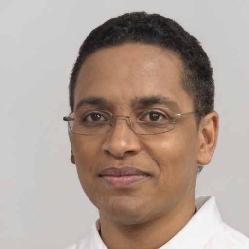 Joyful black adult male with short  black hair and brown eyes