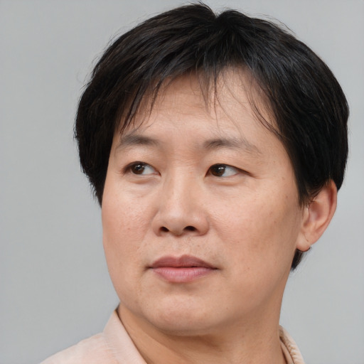 Joyful asian adult male with short  brown hair and brown eyes