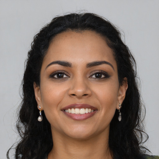 Joyful latino young-adult female with long  black hair and brown eyes