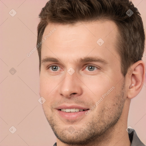 Joyful white young-adult male with short  brown hair and brown eyes