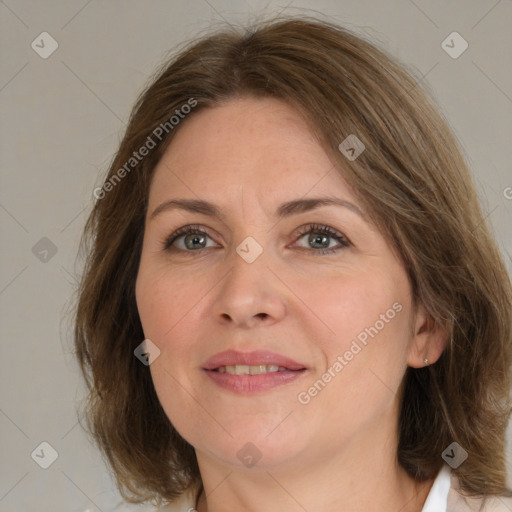 Joyful white adult female with medium  brown hair and green eyes