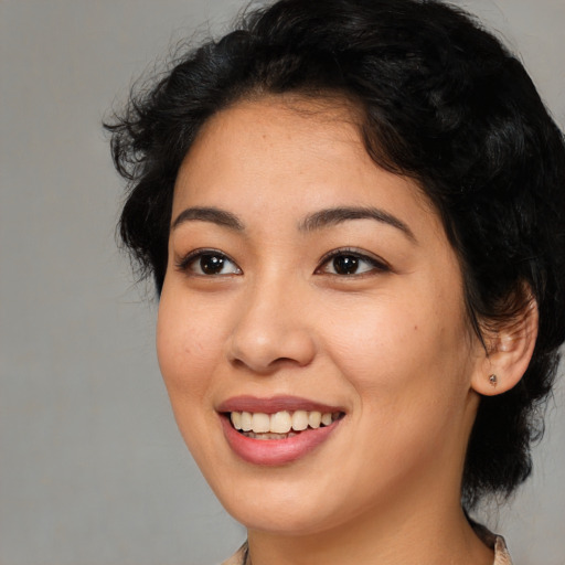 Joyful white young-adult female with medium  black hair and brown eyes