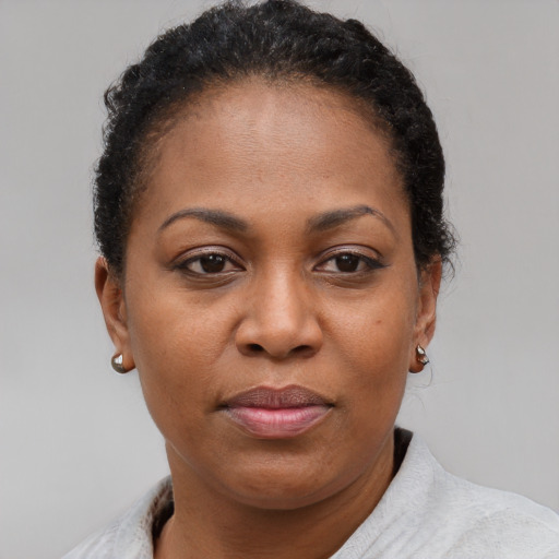 Joyful black adult female with short  brown hair and brown eyes