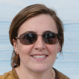 Joyful white young-adult female with medium  brown hair and blue eyes