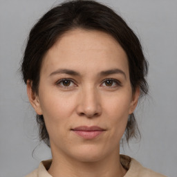 Joyful white young-adult female with medium  brown hair and brown eyes