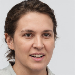 Joyful white adult female with medium  brown hair and brown eyes