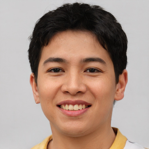 Joyful asian young-adult male with short  brown hair and brown eyes