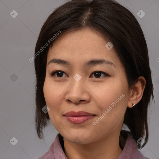 Joyful asian adult female with medium  brown hair and brown eyes