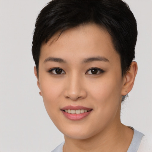 Joyful asian young-adult female with short  brown hair and brown eyes