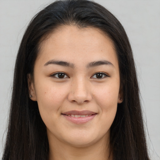Joyful asian young-adult female with long  brown hair and brown eyes
