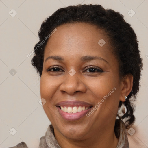 Joyful black adult female with short  brown hair and brown eyes