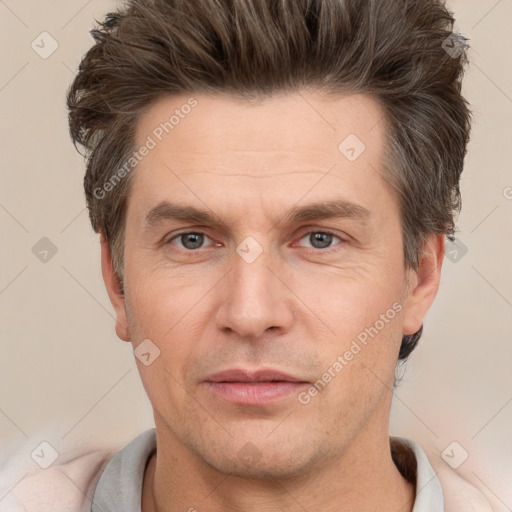 Joyful white adult male with short  brown hair and grey eyes