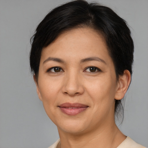 Joyful asian adult female with medium  brown hair and brown eyes