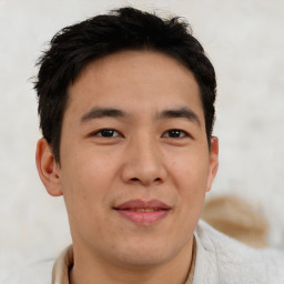 Joyful asian young-adult male with short  brown hair and brown eyes