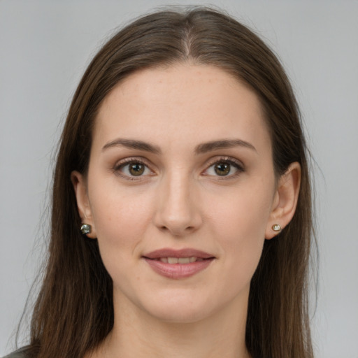 Joyful white young-adult female with long  brown hair and brown eyes