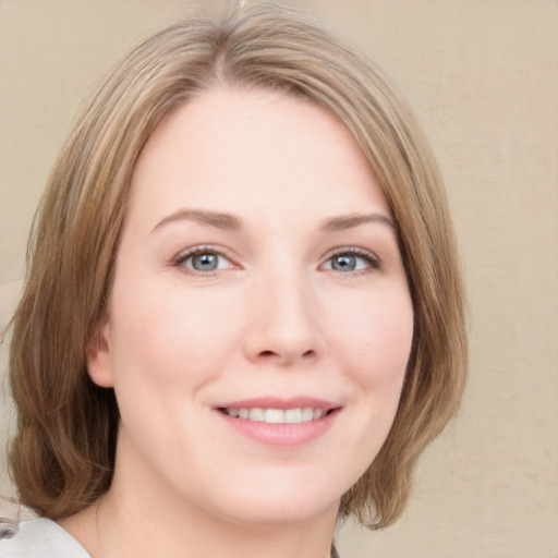 Joyful white young-adult female with medium  brown hair and green eyes